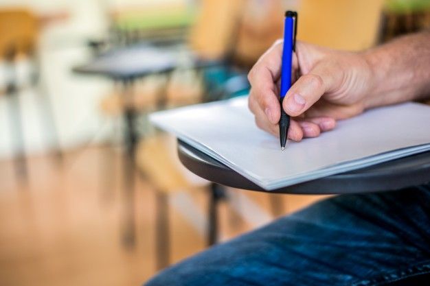 man is writing signing paper focused hand with pen 1391 542